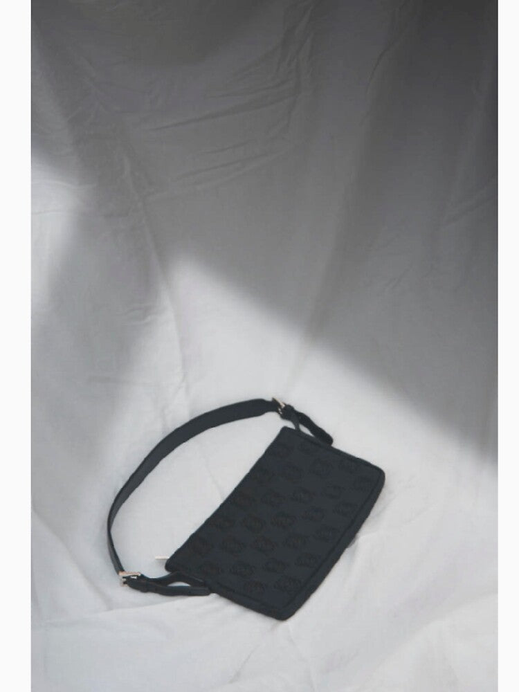 Black handbag on white background by julidescole